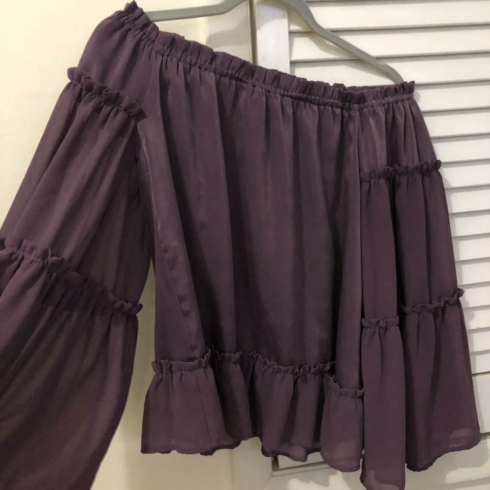 Off shoulder purple blouse.